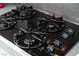 Close up view of a black stovetop with 4 burners, featuring easy-to-use controls at , Las Vegas, NV 89113