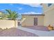 Private backyard with brick paved patio, a wrought-iron gate, and lush landscaping at 10001 Blairwood Ct, Las Vegas, NV 89178