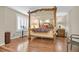 Bedroom featuring a beautifully decorated four-poster bed and natural light from large windows at 10001 Blairwood Ct, Las Vegas, NV 89178