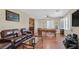 Inviting game room with a pool table, leather sofa, and entertainment setup at 10001 Blairwood Ct, Las Vegas, NV 89178