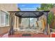 Hot tub under a gazebo with open side provides view of the yard beyond at 10001 Blairwood Ct, Las Vegas, NV 89178