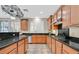 Charming kitchen featuring wood cabinetry and natural light through shuttered windows at 10001 Blairwood Ct, Las Vegas, NV 89178
