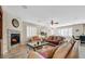 Inviting living room featuring a cozy fireplace and comfortable leather sofas at 10001 Blairwood Ct, Las Vegas, NV 89178