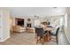 Open-concept living area with fireplace, dining table, and white grand piano at 10001 Blairwood Ct, Las Vegas, NV 89178