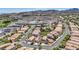 Aerial view of a community filled with single Gathering homes, desert landscaping and mountain views at 1008 Welkin St, Henderson, NV 89052