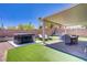 Backyard is set up for relaxing with a jacuzzi and a covered seating area at 1008 Welkin St, Henderson, NV 89052