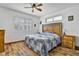 Cozy bedroom with wood floors, ceiling fan, and a large window at 1008 Welkin St, Henderson, NV 89052