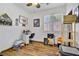 Office bedroom with wood floors, ceiling fan, and a big window at 1008 Welkin St, Henderson, NV 89052