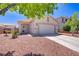 Charming single-story home with a two-car garage and desert landscaping at 1008 Welkin St, Henderson, NV 89052