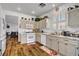 Bright kitchen with wooden floors, white cabinets, and stainless steel appliances at 1008 Welkin St, Henderson, NV 89052