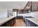 Kitchen features an island with sink, quartz countertops, and modern stainless appliances at 10184 Juniper Valley St, Las Vegas, NV 89166