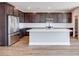 Spacious kitchen with a center island and stainless steel appliances and dark cabinets at 10184 Juniper Valley St, Las Vegas, NV 89166