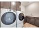 Bright laundry room with side-by-side washer and dryer plus lots of storage at 10184 Juniper Valley St, Las Vegas, NV 89166
