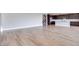 Expansive living room with wood floors leading into an open concept kitchen at 10184 Juniper Valley St, Las Vegas, NV 89166