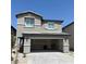 Charming two-story home with a two-car garage and stone accents against a bright blue sky at 10406 Luna Mezza Ave # Lot 192, Las Vegas, NV 89141