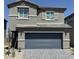 Charming two-story home featuring a gray stucco facade, and a two-car garage, offering a cozy, modern living space at 10406 Luna Mezza Ave # Lot 192, Las Vegas, NV 89141