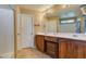 Spacious bathroom features a dual sink vanity, tile floors, and a shower-tub combo at 10583 Mann St, Las Vegas, NV 89141