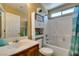 Well-lit bathroom features a shower-tub combo with white tile and built-in storage shelves at 10583 Mann St, Las Vegas, NV 89141