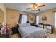 Comfortable bedroom with ceiling fan, neutral colors, and plenty of natural light from large windows at 10583 Mann St, Las Vegas, NV 89141