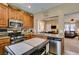 Bright kitchen with stainless steel appliances and open view to the dining and living areas at 10583 Mann St, Las Vegas, NV 89141