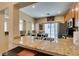 Granite counters and stainless appliances are featured in this kitchen with island and slider to the back yard at 10583 Mann St, Las Vegas, NV 89141