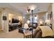Open-concept living room featuring plush leather seating and a large screen television at 10583 Mann St, Las Vegas, NV 89141