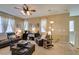 Comfortable living area features carpet flooring, neutral walls, and lots of natural light from the windows at 10583 Mann St, Las Vegas, NV 89141