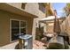 Cozy outdoor patio with barbeque, small gravel bed, and white fence at 10583 Mann St, Las Vegas, NV 89141