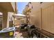 Cozy outdoor patio with barbeque, small gravel bed, and white fence at 10583 Mann St, Las Vegas, NV 89141