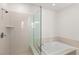 Modern bathroom features a separate shower and soaking tub with neutral color palettes at 1075 Page Park Ln, Henderson, NV 89011