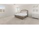 Well-lit bedroom featuring plush carpeting and two windows with shutters at 1075 Page Park Ln, Henderson, NV 89011