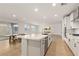 Modern kitchen with quartz counters, stainless appliances, and seamless flow to the backyard at 1075 Page Park Ln, Henderson, NV 89011
