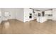 Open kitchen with hardwood floors, white cabinets, and a large center island at 1075 Page Park Ln, Henderson, NV 89011