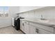 Efficient laundry room featuring a modern washer and dryer plus ample counter space at 1075 Page Park Ln, Henderson, NV 89011
