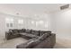 Comfortable loft area with a large sofa and natural light at 1075 Page Park Ln, Henderson, NV 89011
