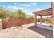 Enclosed backyard with privacy block wall, gravel ground cover and covered patio area at 11749 Villa San Michele Ct, Las Vegas, NV 89138