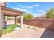 Covered patio with desert landscape and low block wall for privacy from adjacent properties at 11749 Villa San Michele Ct, Las Vegas, NV 89138