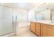 Bright bathroom features double sinks, tub, and separate glass enclosed shower at 11749 Villa San Michele Ct, Las Vegas, NV 89138