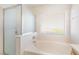 Bright bathroom featuring a tub and a separate glass-enclosed shower at 11749 Villa San Michele Ct, Las Vegas, NV 89138