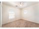 Carpeted bedroom with ceiling fan and two windows at 11749 Villa San Michele Ct, Las Vegas, NV 89138