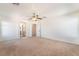 Spacious carpeted bedroom featuring a ceiling fan and an ensuite bathroom at 11749 Villa San Michele Ct, Las Vegas, NV 89138