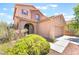 Inviting two-story home with a well-manicured front yard, arched entry, and a two-car garage at 11749 Villa San Michele Ct, Las Vegas, NV 89138