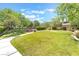 Community greenspace with mature trees, manicured bushes and grassy lawn areas at 11749 Villa San Michele Ct, Las Vegas, NV 89138