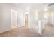 Bright hallway with carpet, leading to a bathroom and bedrooms, creating a seamless transition between spaces at 11749 Villa San Michele Ct, Las Vegas, NV 89138