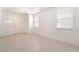 Bright, spacious living room featuring tile floors, white walls, and natural light from multiple windows at 11749 Villa San Michele Ct, Las Vegas, NV 89138