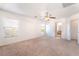 Generous bedroom with carpeting, windows, ceiling fan, offering a serene retreat with en-suite bathroom access at 11749 Villa San Michele Ct, Las Vegas, NV 89138
