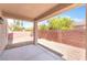 Covered patio offering shade, desert landscaping, and block wall for extra privacy at 11749 Villa San Michele Ct, Las Vegas, NV 89138