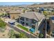 Aerial view of two-story home with backyard, covered patio, landscaping, outdoor kitchen and lounge areas at 12332 Switchgrass Ave, Las Vegas, NV 89138