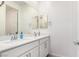 Modern bathroom with double vanity, white cabinets, chrome hardware, and framed mirrors at 12332 Switchgrass Ave, Las Vegas, NV 89138