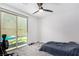 Neutral bedroom with a ceiling fan and sliding glass door to the backyard at 12332 Switchgrass Ave, Las Vegas, NV 89138